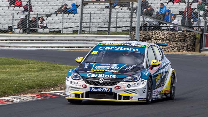 Liveried CarStore PMR Vauxhall Astra racing around Brands Hatch