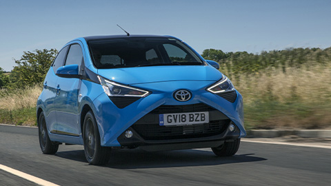 Blue Toyota AYGO, driving