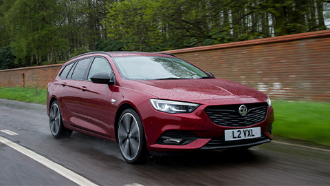 Red Vauxhall Insignia Estate, driving