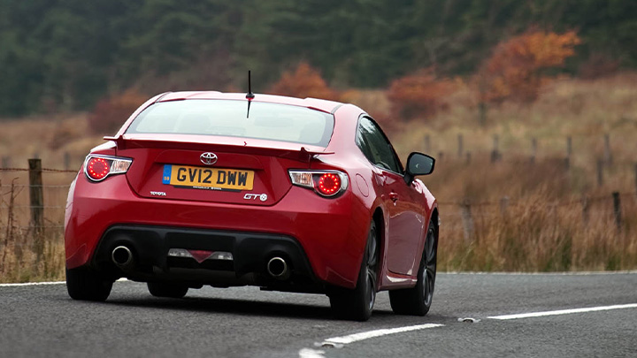 Red Toyota GT86, rear, driving