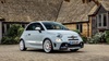 Abarth 595 parked in front of a house