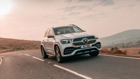 Silver Mercedes GLE driving in the country side