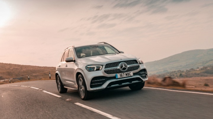 Silver Mercedes GLE driving in the country side